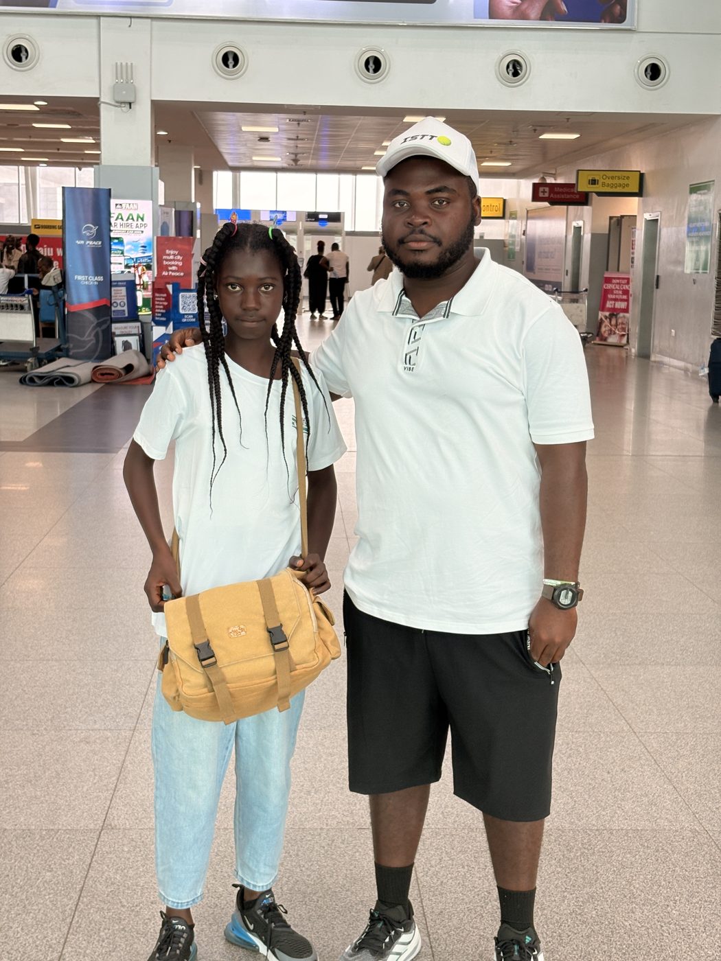 Helen with her coach at the airport